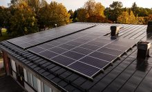 Solar panels in remote and rural households - solar panels on the roof of a rural house near a forest